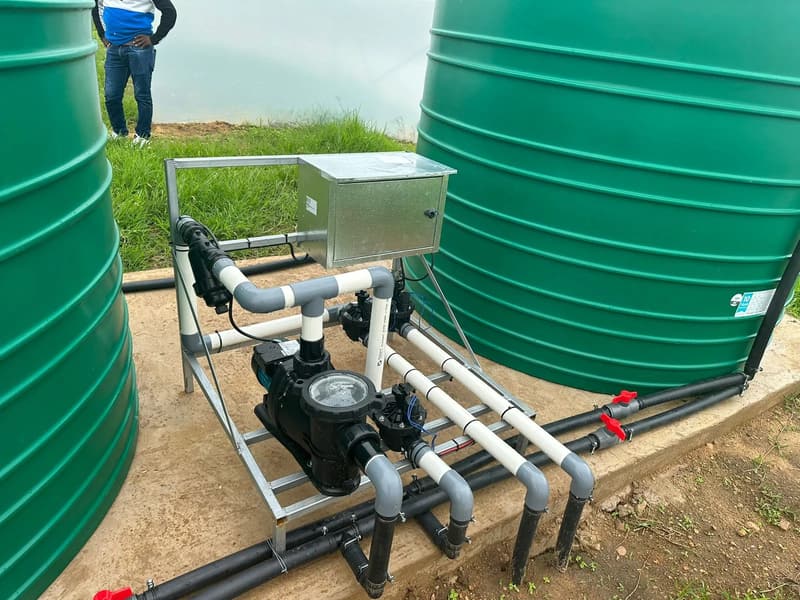 Irrigation pump station with filter and valves between two green water tanks