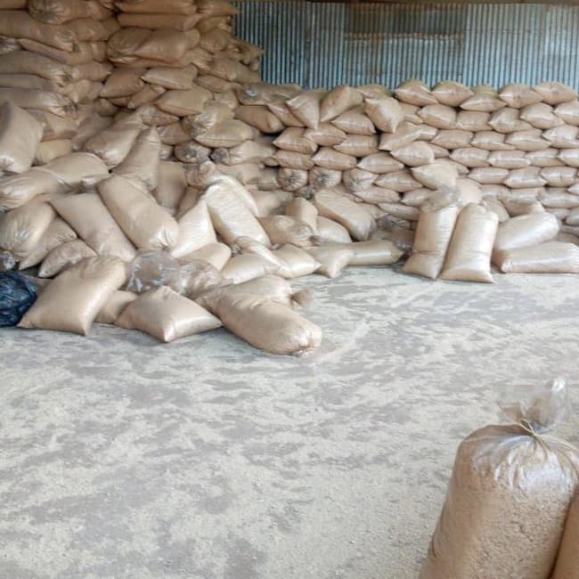 Bags of sawdust stacked in a store
